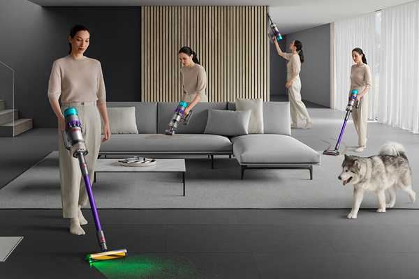A woman vacuuming carpet and hard floors with a Dyson Gen 5 detect vacuum cleaner using different attachments for stairs and windows.